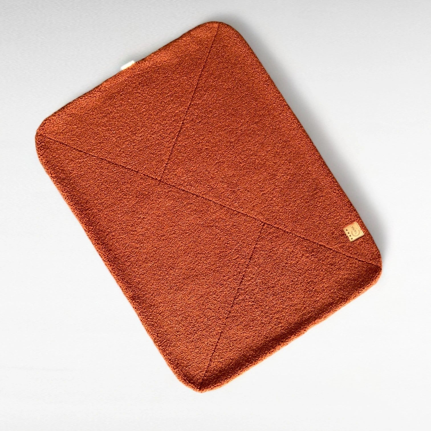 Terracotta-farbene rechteckige Hundedecke mit abgerundeten Ecke und Ziersteppungen aus hochwertigem Boucle-Stoff