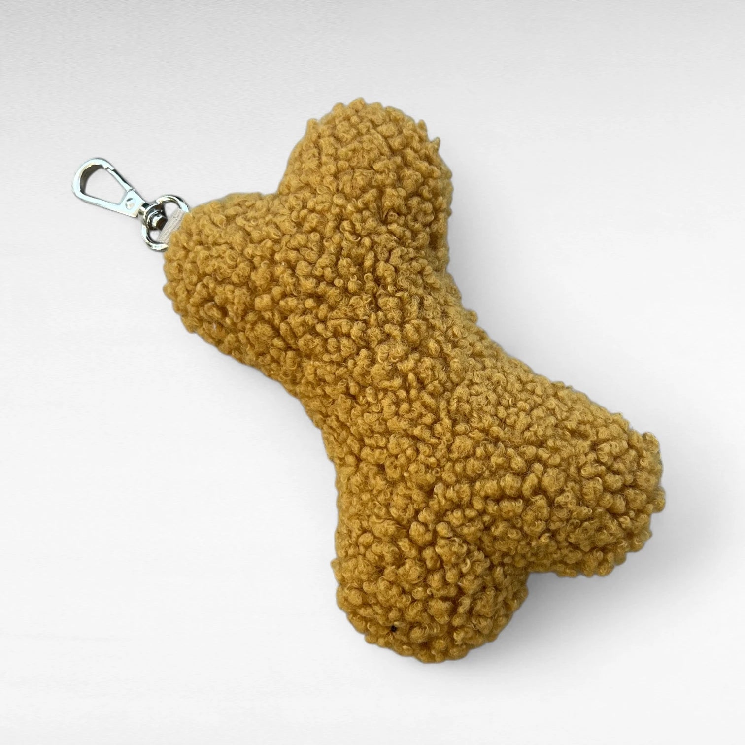 Modischer Taschenanhänger in Knochenform aus safranfarbenem Boucle